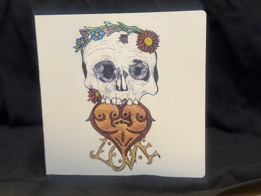 Card with a skull and heart design on a black background