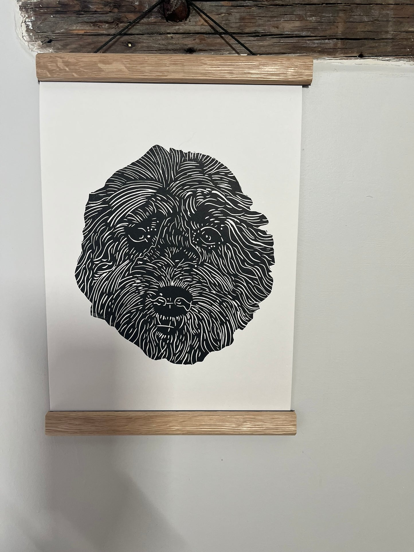Black and white illustration of a dog's head on a white background with a wooden frame.
